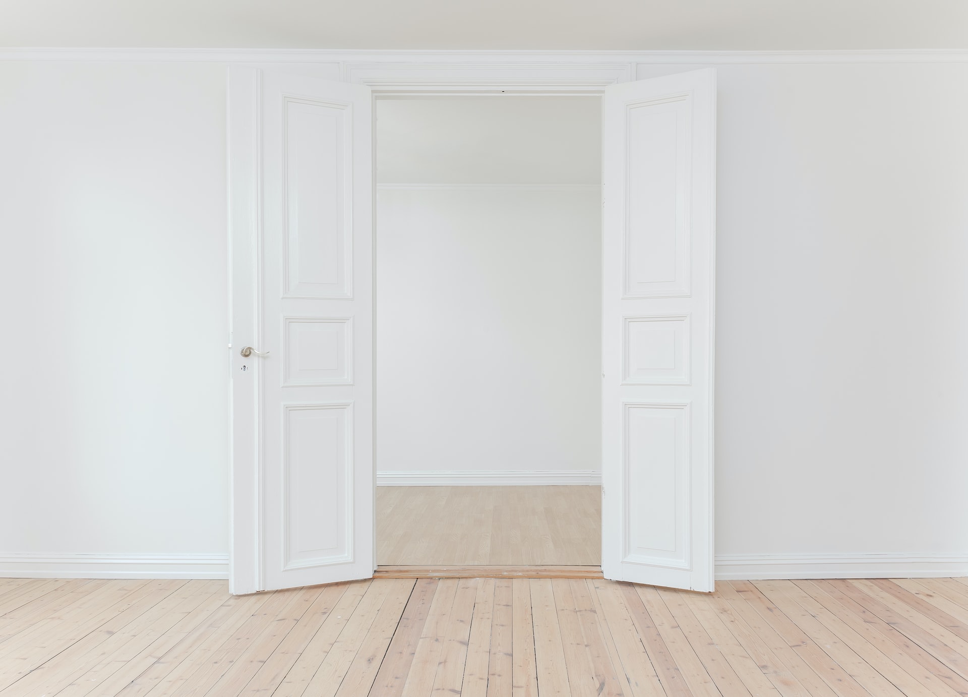 white wall with open white doors