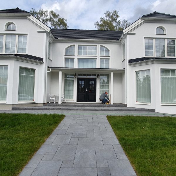 a bid modern house with a well-kept yard