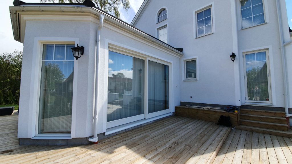 a side of a house with a wooden floor