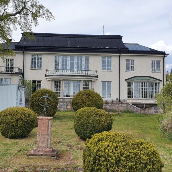 an old stylish house with a well-kept garden